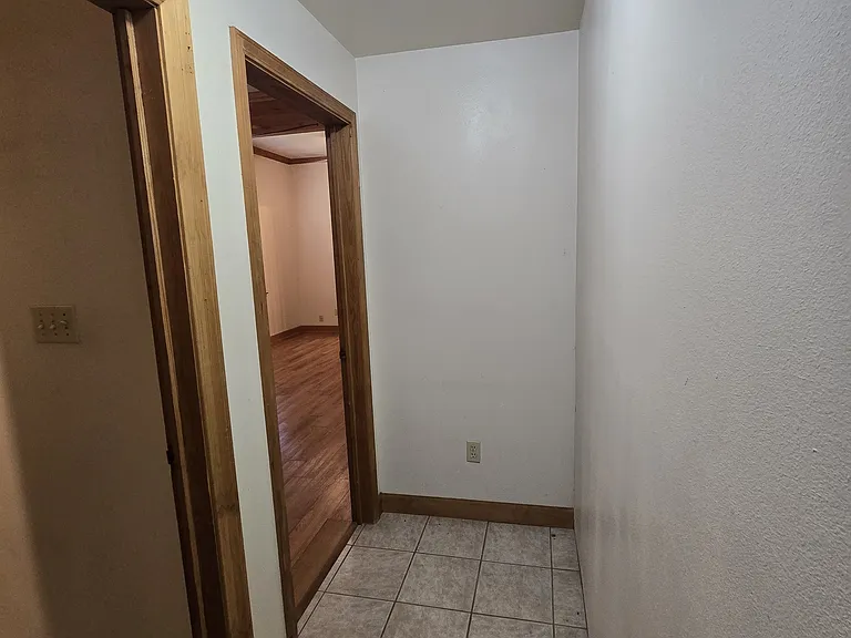 Hallway connecting laundry room and bedroom
