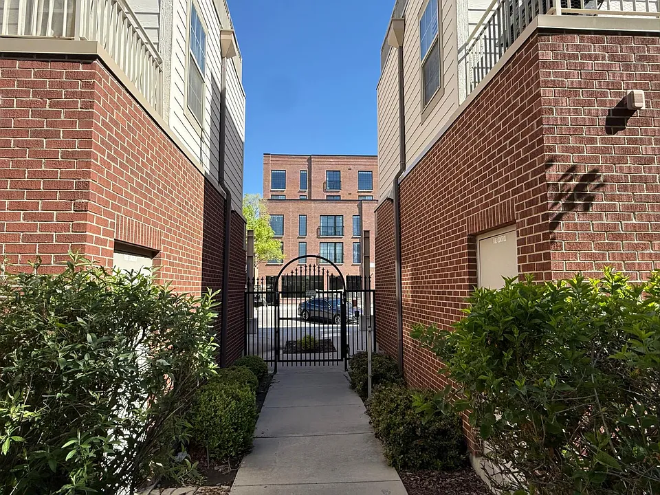 View out to 25th Street from the community gate. Easy touch pad code access makes it seemless for residents.