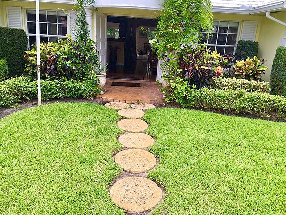 Entry from driveway to double door front entry.