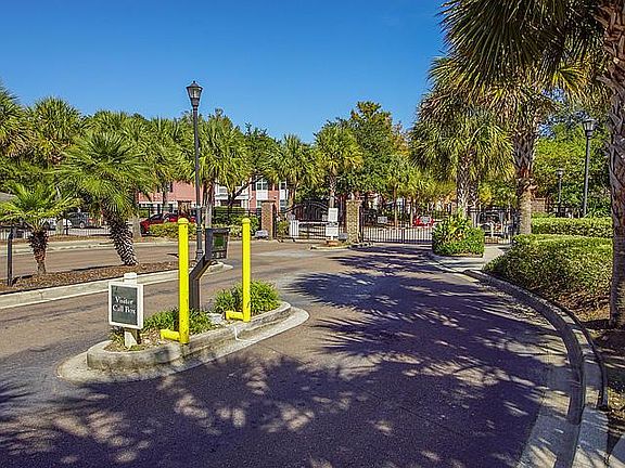 Gated entrance with owner access on left and kiosk box for guests and vendors on right