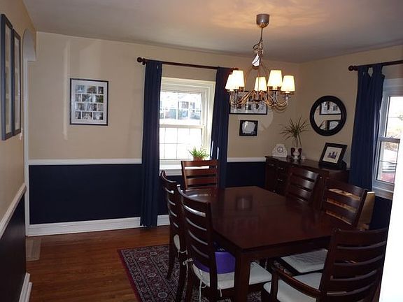 Dining room with hardwood floors (throughout), deep windowsill, and chairrail