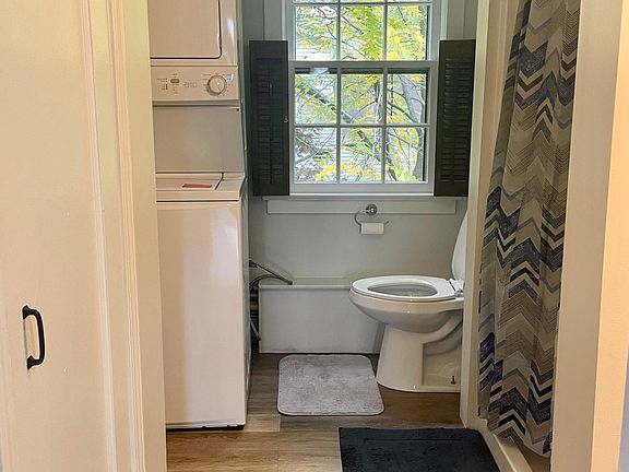 Bathroom with standup shower and in-unit washer and dryer.
