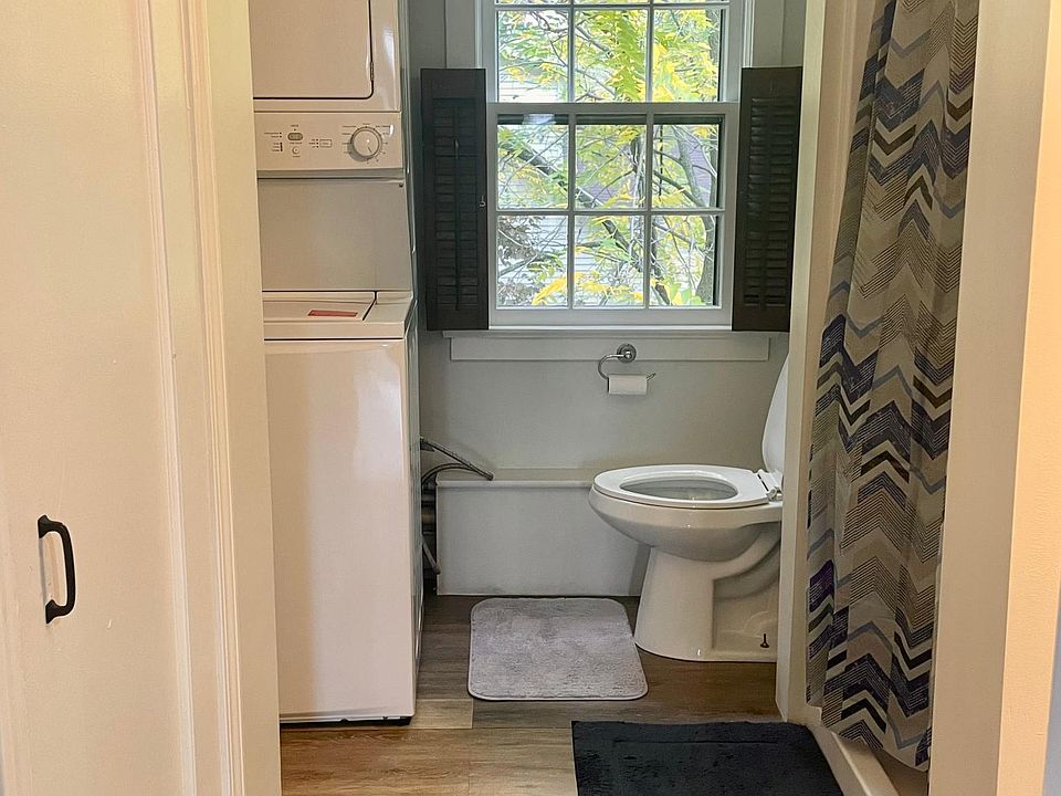 Bathroom with standup shower and in-unit washer and dryer.