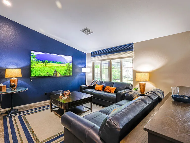 Open plan living room, dining room, kitchen, entry way.
Living room has 2 leather couches with queen size hide away bed, dining table seats 10, sliding door to patio seating