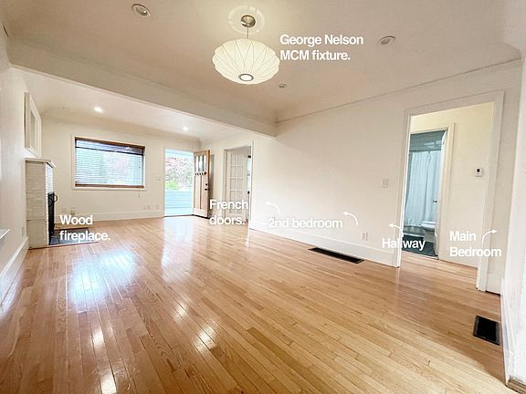 Modern x Classic.

Craftsman details (beautiful front door, french doors in living room / front bedroom/studio space, fireplace, balanced nicely with mid century modern fixtures throughout like this classic George Nelson pendant from DWR.
