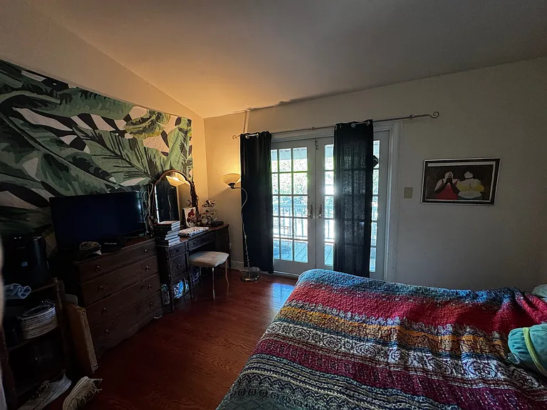 Bedroom with deck beyond.