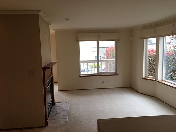 Living room bright and with a fireplace - open to dining roo