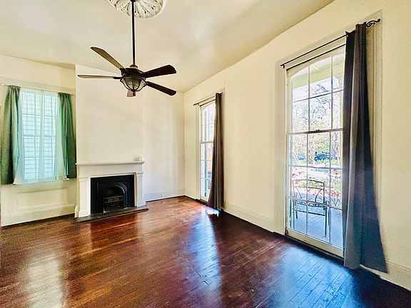 Living room with custom made carriage doors that swing open into dinette area
