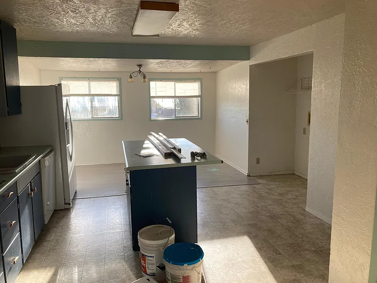 Kitchen with laundry alcove to the right side