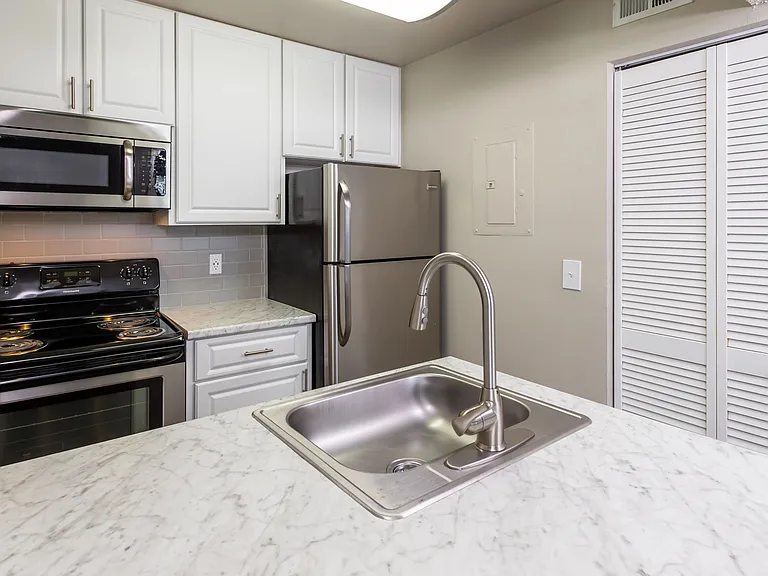 Your culinary sanctuary awaits with fully equipped renovated kitchens, offering opulent features like subway tile backsplash and marble-inspired countertops.