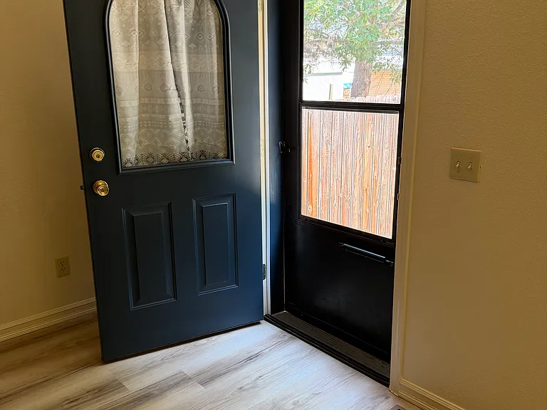 Dining room with door to back yard and off-street parking.