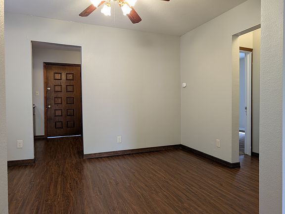This is a picture of the dining room. The kitchen is through the left doorway. The hall is through the right doorway.