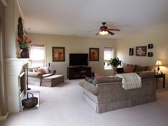 Family Room w/ ceiling fan, newer carpet & neutral colors.