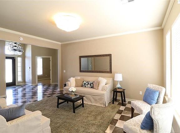 Living room from den and kitchen area. Looking into entry and office/study.