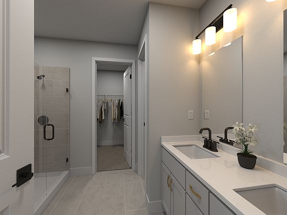 The primary bathroom offers dual vanity sinks and a walk-in shower.