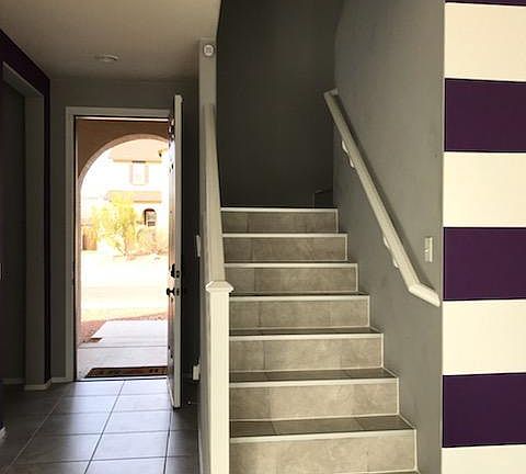 Front door, half bath to back left, kitchen to right, living room to left.