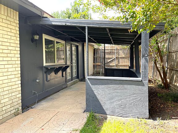Covered patio off kitchen with passthrough window.