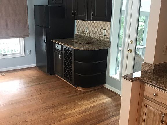 Eat-in area of kitchen with second refrigerator and wine rack