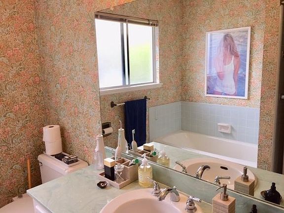 The bathroom has both a tub and separate shower.