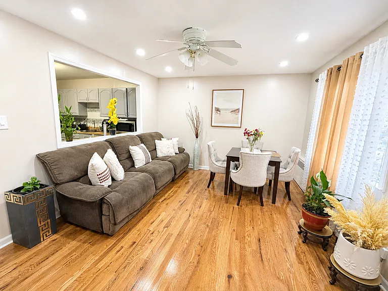Bright and spacious shared living room with hardwood floors, comfortable seating and a dining area.