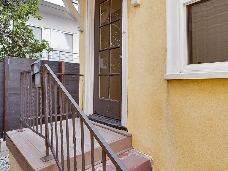 Walk up to your front door in this courtyard style 1910 Spanish bungalow