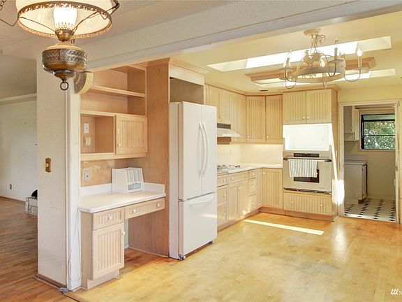 Bright light filled kitchen with skylight and slider to deck.>