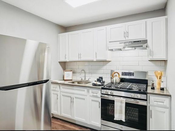 Spacious kitchen with stainless steel appliances and gas stove