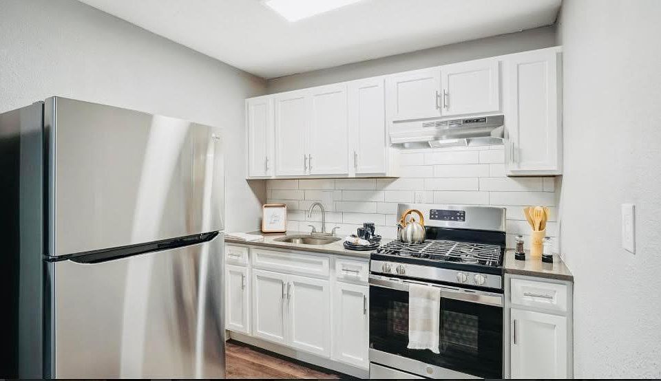 Spacious kitchen with stainless steel appliances and gas stove