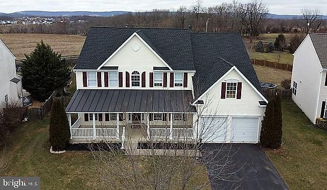 Spacious colonial with front porch on .42 acre lot