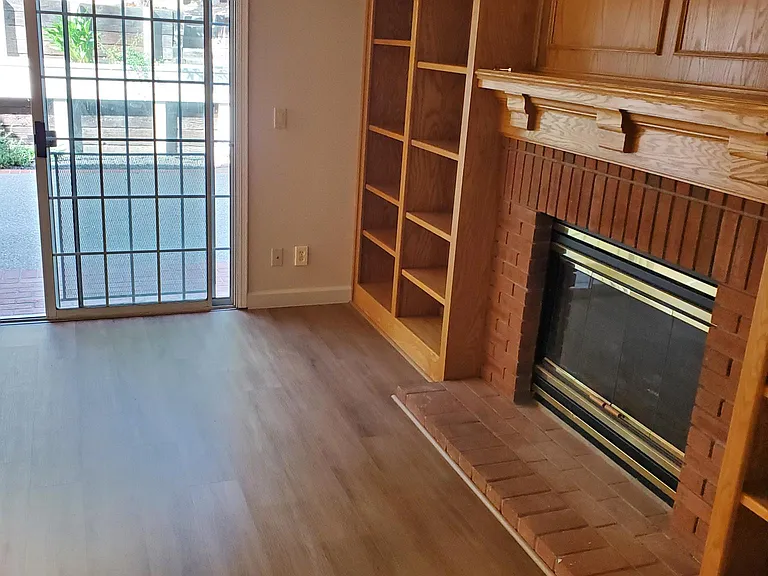 View of right-side of family room with bookcase and fireplace