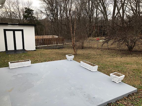 Fenced in backyard and storage building