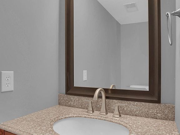 Half bathroom on the 1st floor with granite counters.