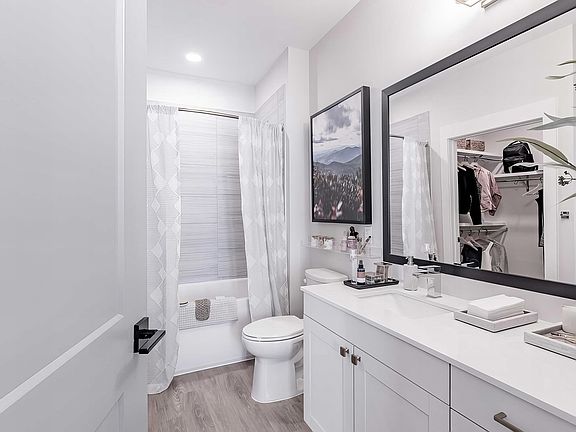 Full bathroom with a bathtub with tile backdrop