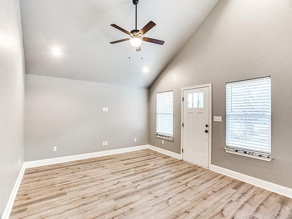 Open Concept Living/ Dining/ High Ceilings with recessed lighting and ceiling fan in Living room.