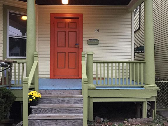 Steps' risers have since been painted olive. Building has been cleaned, pressure washed, painted in 'painted lady' colorful styling