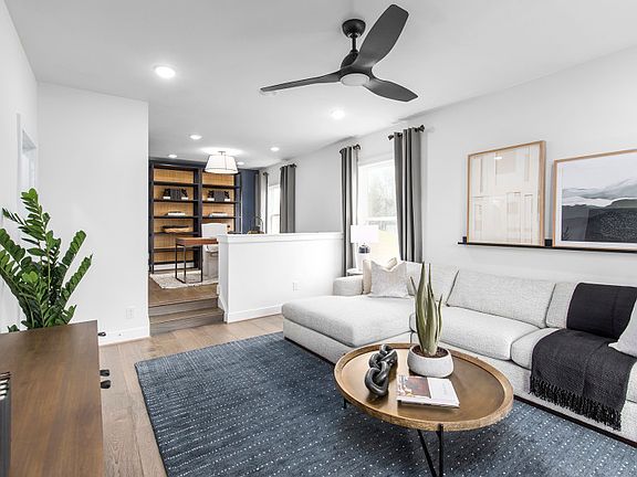 Model Representation - Casual Living Room and Home Office Located off the Foyer