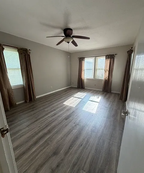 light filled master bedroom with ceiling fan