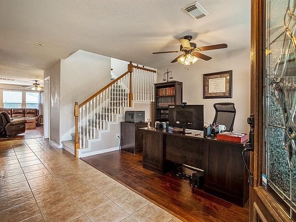 Looking into the study at the front of the home. The front door has a top glass section with allows plenty of light to reflect into an inviting entryway.