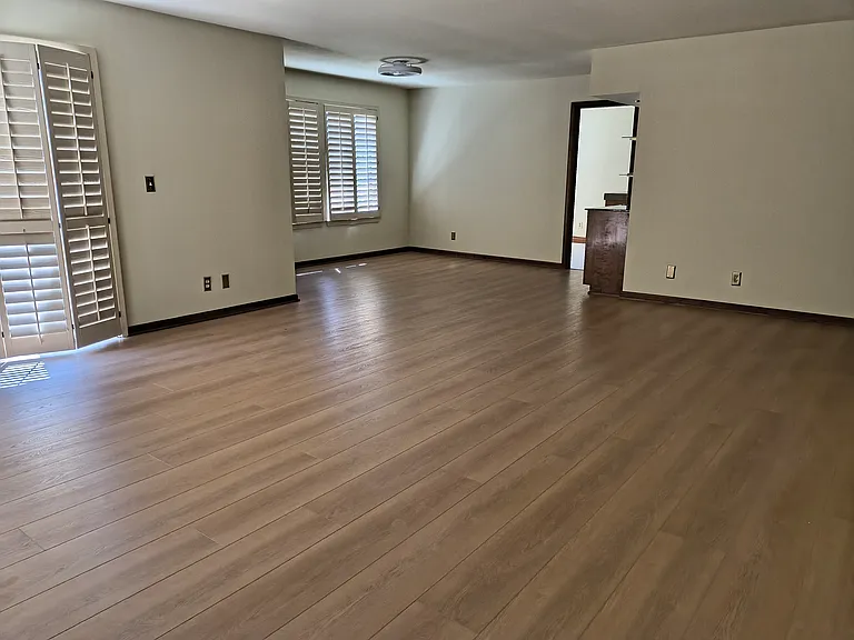Set up as extended living room or formal dining room. Beautiful new floors. plus, a bar area.