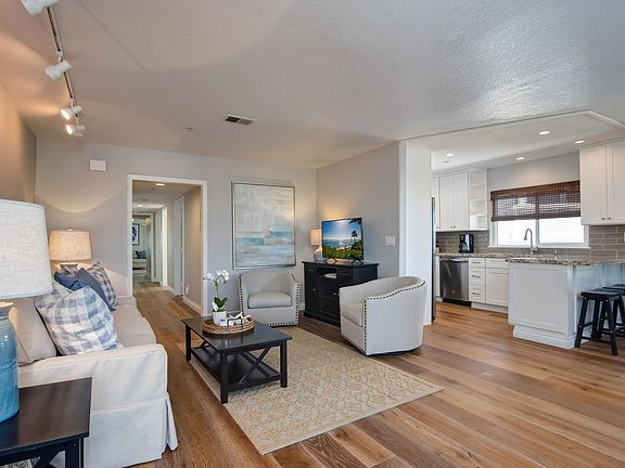 Airy open floor plan. Hallway off of living area leads to bedrooms.