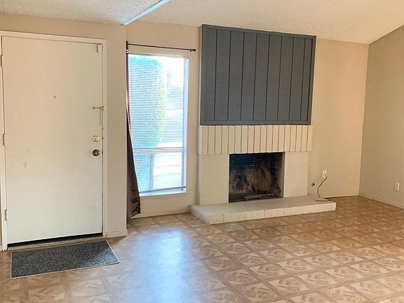 Front door and fireplace in living room.