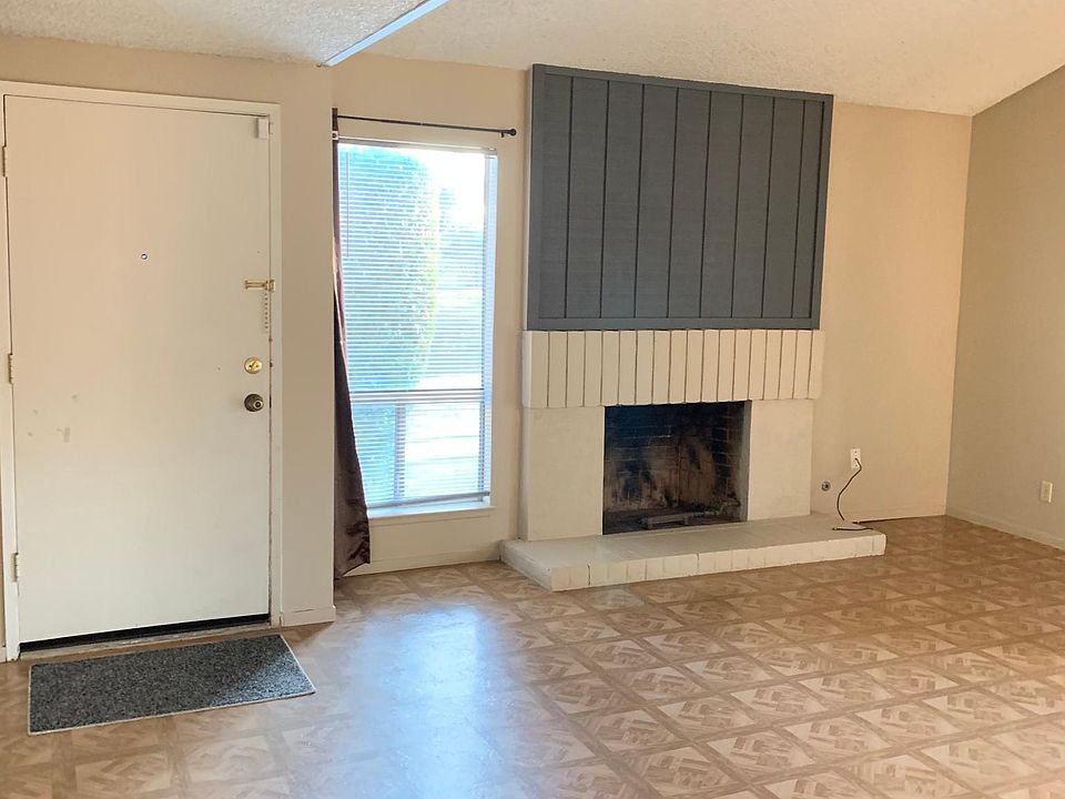 Front door and fireplace in living room.