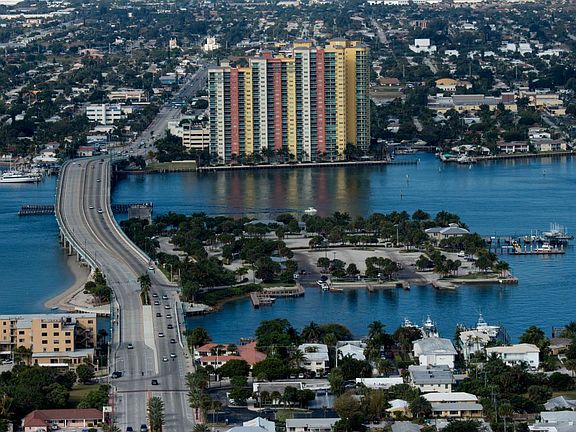 Property is on the south side of the Blue Heron bridge, opposite the tall colorful condominium buildings.