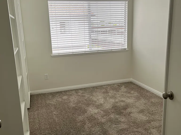 Secondary bedroom with built-in bookcases