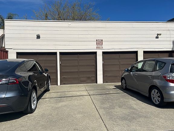 Photo of inside electric keypad garage space and outside additional parking space.