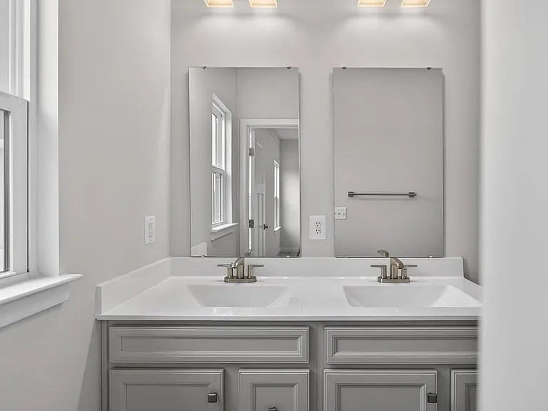 Master bathroom with dual sinks and culture marble countertops