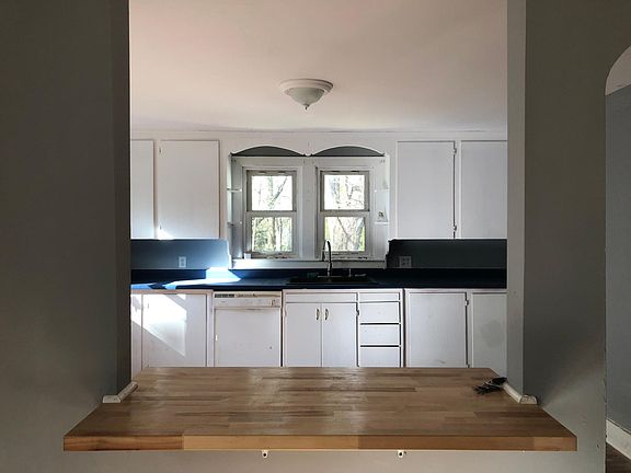 view from living room looking thru open concept breakfast bar into kitchen