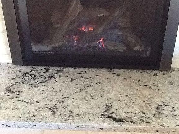 Gas fireplace with granite hearth.