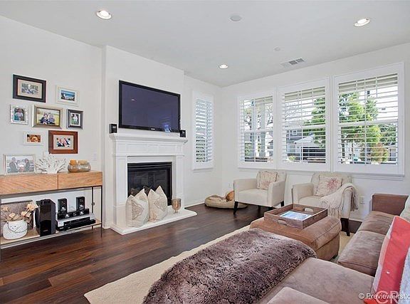 Great room with hardwood floors, tall ceilings, custom blinds and fireplace