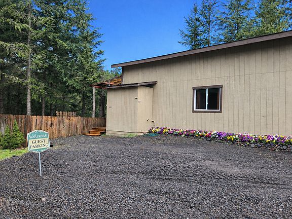 The apartment is behind our shop. You do have two designated parking spots and the entry to the apartment is up those stairs by the fence.